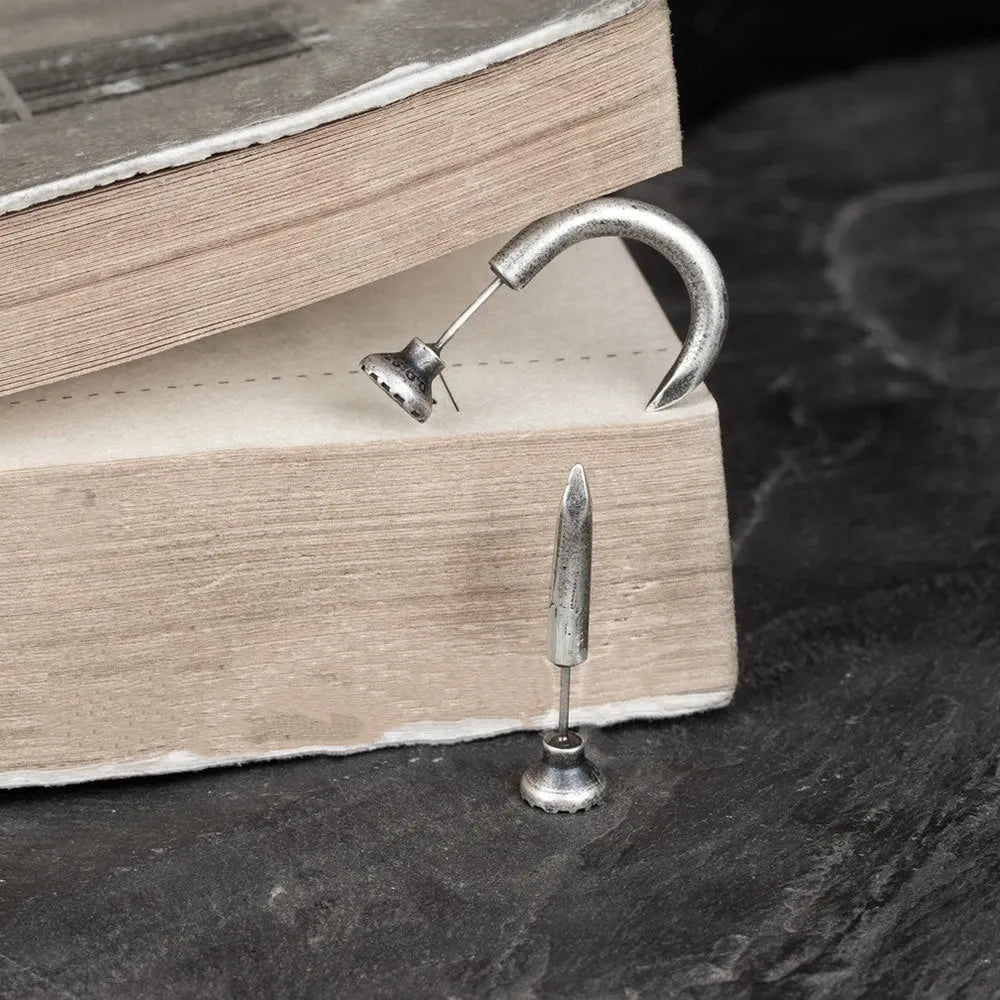 Sterling silver nail stud earrings in straight or curved punk style on ear hook.