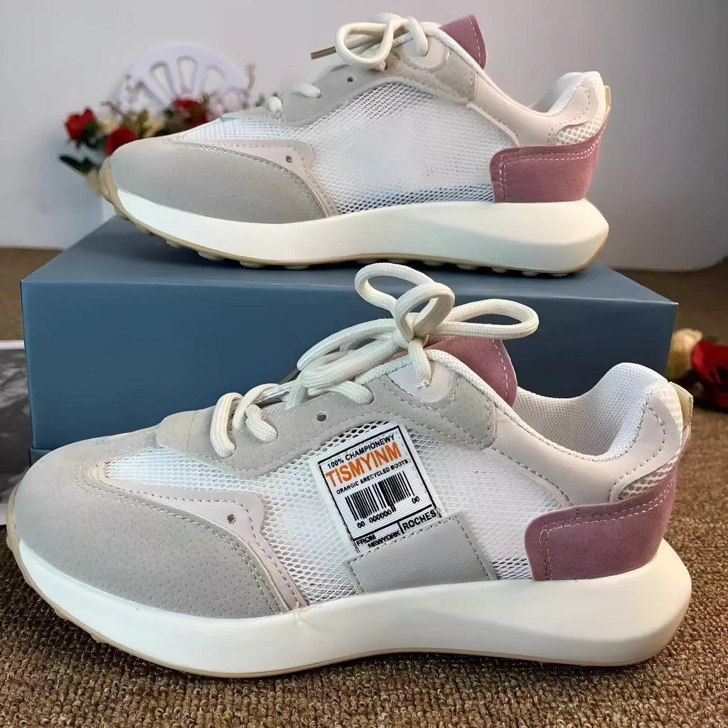 Women's grey and pink retro sneakers with mesh lining, rubber sole, and round toe design
