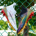 Men's high-top football shoes with gold plated sole in white, black, and mandarin duck colours.