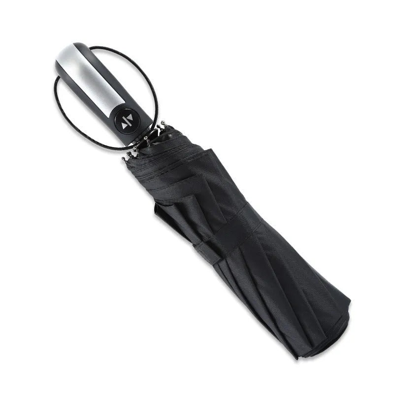 Large black triple folding automatic business umbrella with a steel frame and rubber handle, shown open.