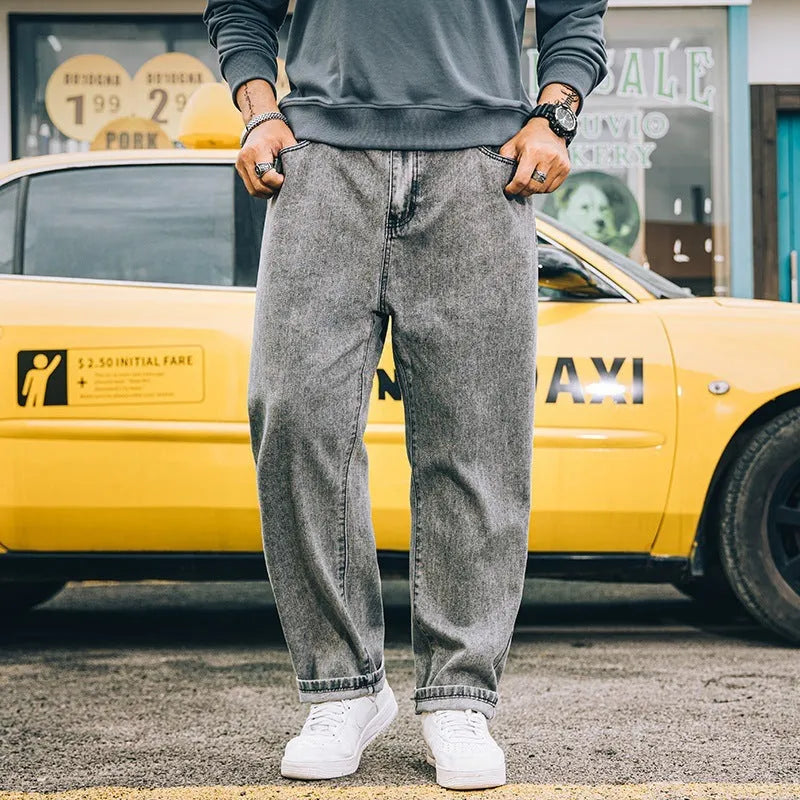 Men's loose straight-leg jeans in cotton denim, shown in dark blue, with a zipper fly and mid-rise waist.