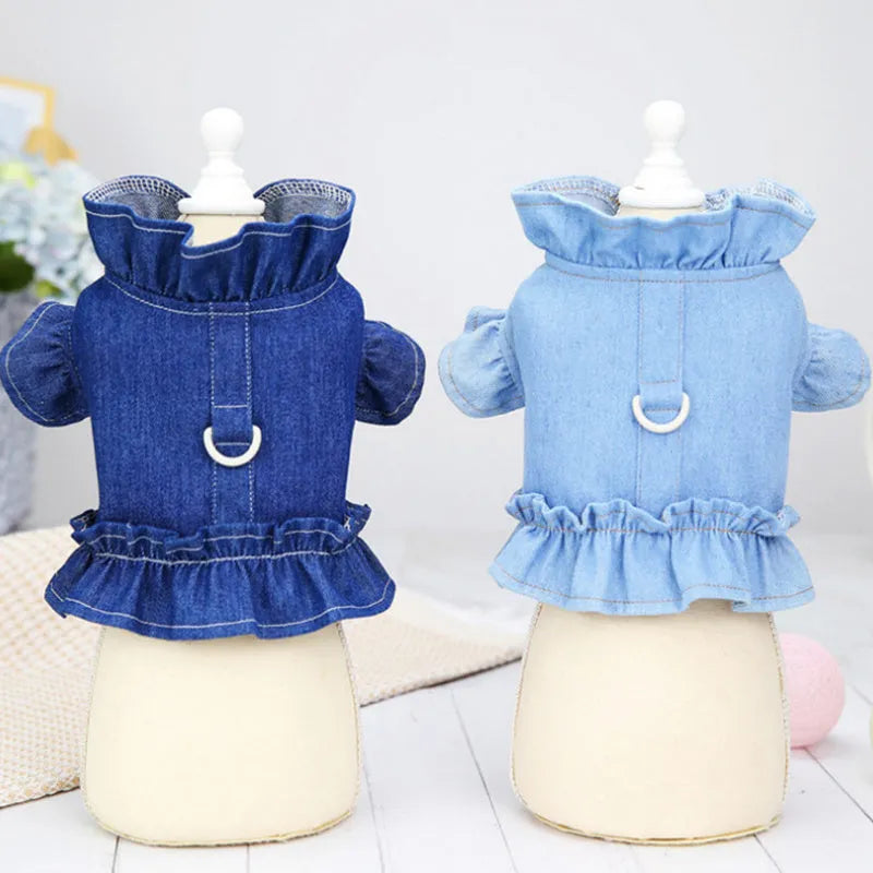 Blue denim dog dress with ruffles and integrated leash hooks on the chest and back.