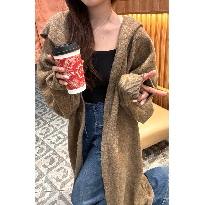 Women's long hooded cardigan in wool blend fabric showing below-the-knee length and loose fit silhouette