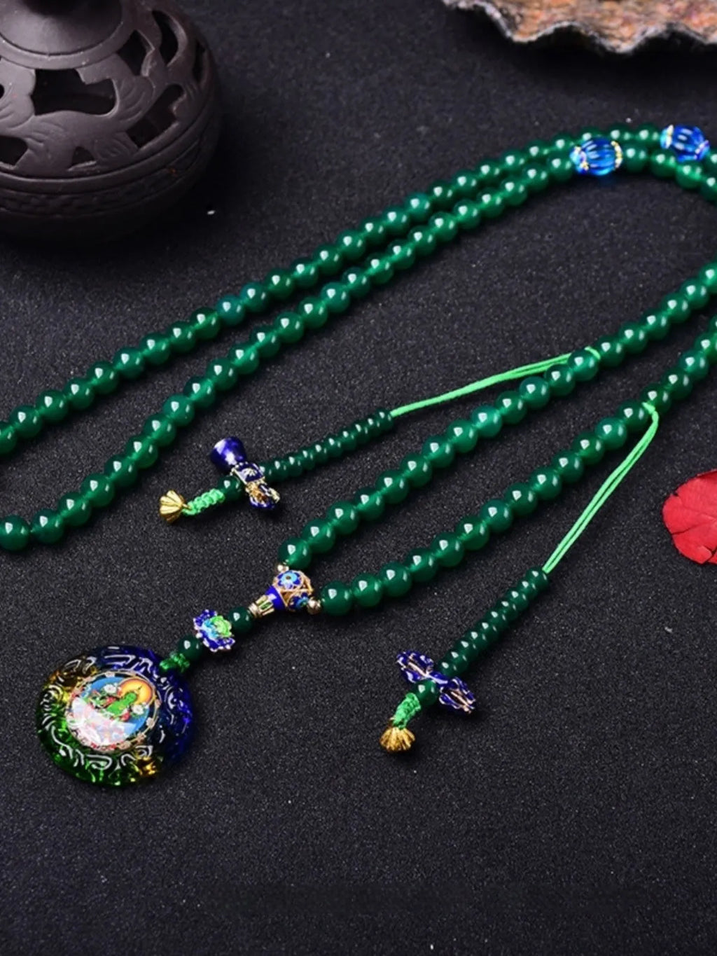 Handmade green agate bracelet with a detailed thangka pendant and multi-circle bead design.