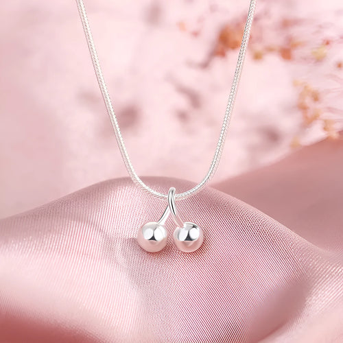 Silver cherry pendant necklace on an adjustable snake bones chain for women.