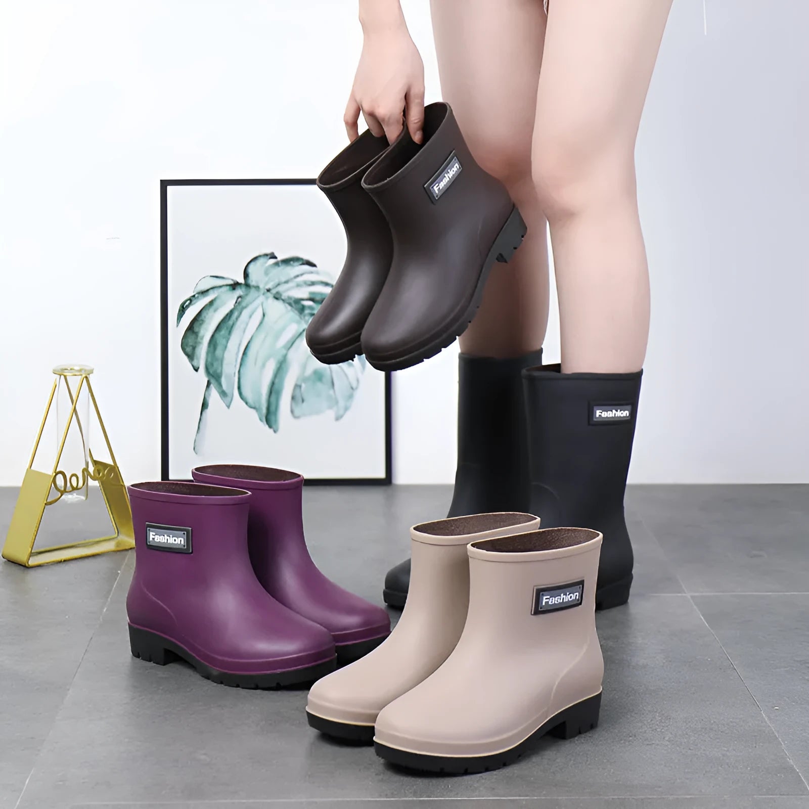 Women's black PVC rain boots with mid-calf height and low heel