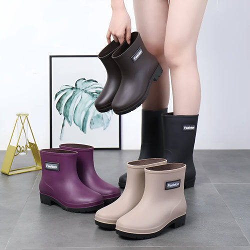 Women's black PVC rain boots with mid-calf height and low heel