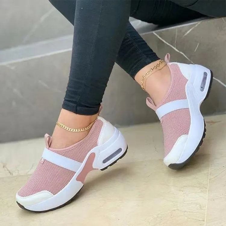 Women's flat mesh sneakers in light grey with white rubber soles and colour stitching.