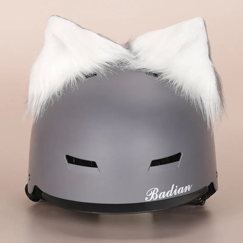 Plush fabric ski helmet decoration with cartoon design on a black ski helmet.