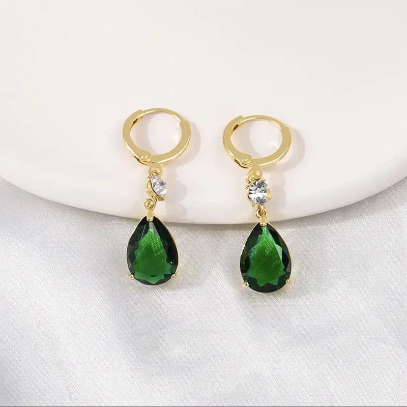 A pair of green geometric teardrop-shaped alloy earrings on a white background.