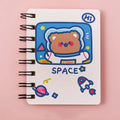 Astronaut-themed pocket notebook with flip closure showing 10.5 × 8 cm dimensions