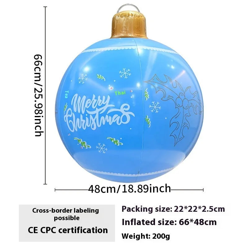 Large red and white inflatable Christmas ball with snowflake design in garden setting