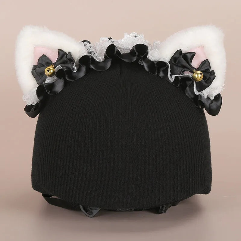 Plush fabric ski helmet decoration with cartoon design on a black ski helmet.