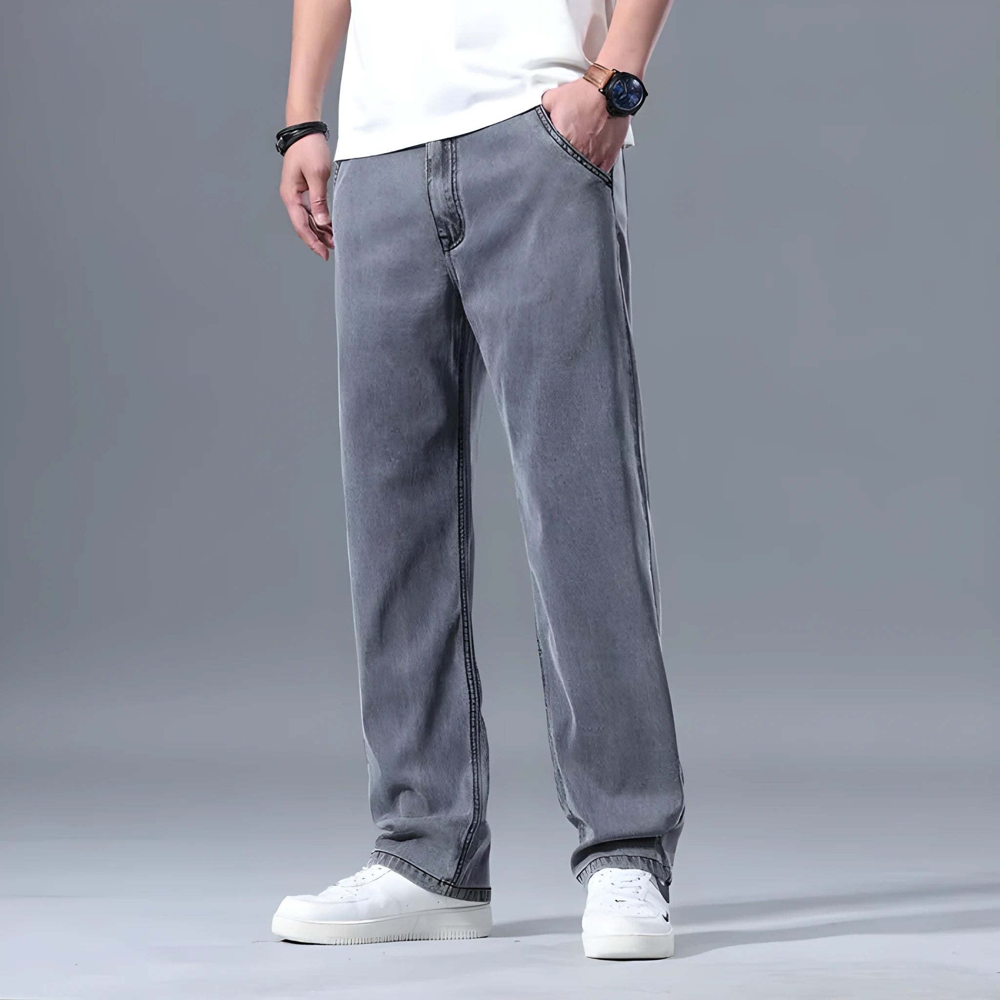 Man wearing loose fit light blue straight-leg lyocell jeans with a zip fly.