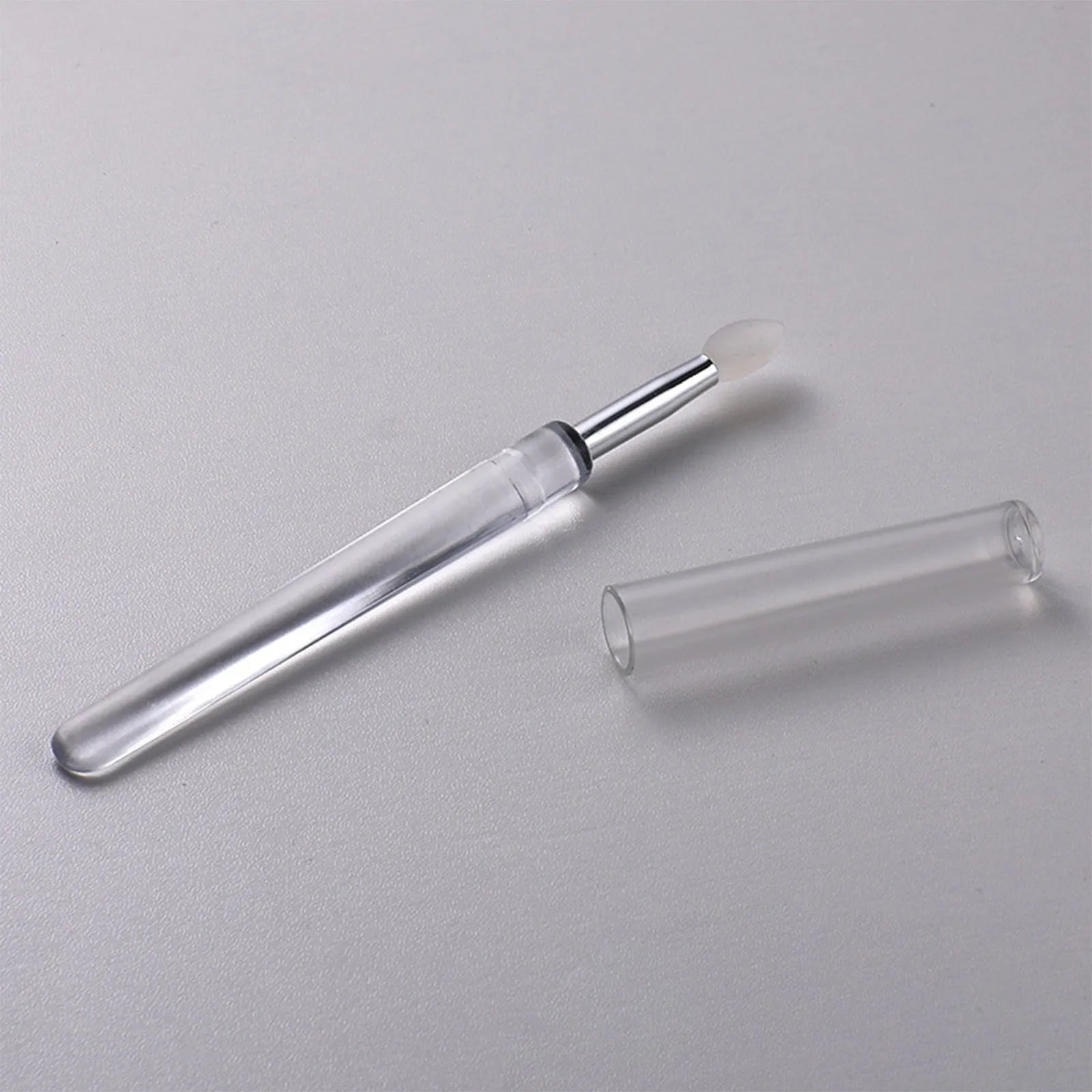 Set of silicone lip brushes with caps in various colours including blue, pink, and purple.