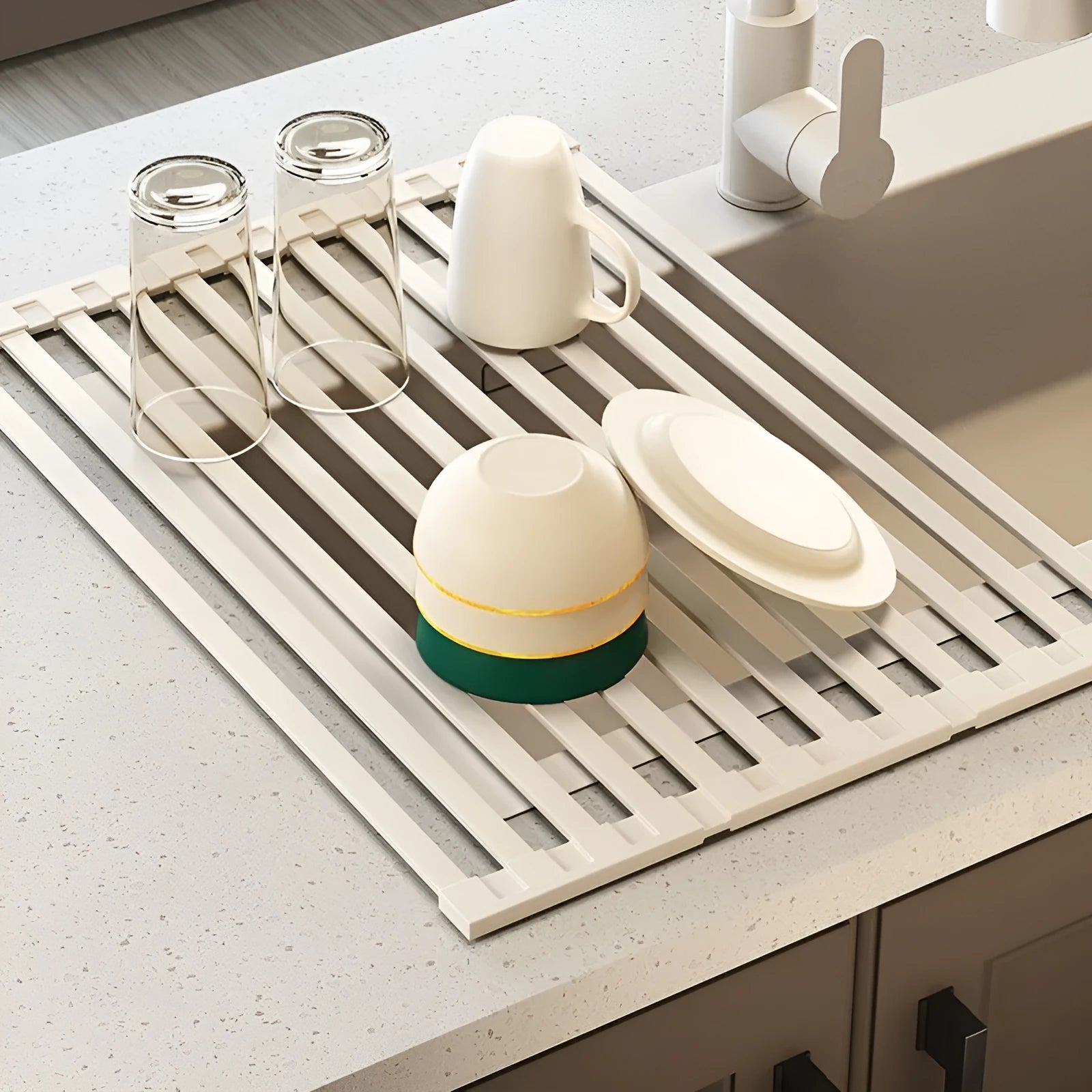 Milky white foldable stainless steel kitchen draining rack for dishes on a countertop