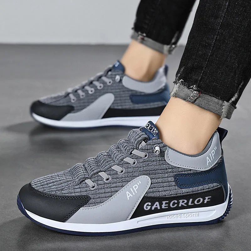 Men's grey and green mesh running shoes with round toe and lace-up design shown from side view