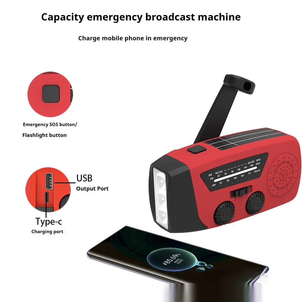 Red hand-crank emergency radio torch with solar panel, LED flashlight, and USB charging port.