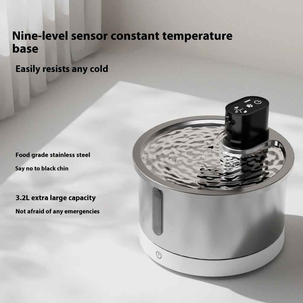 Stainless steel pet water fountain with heated base on countertop