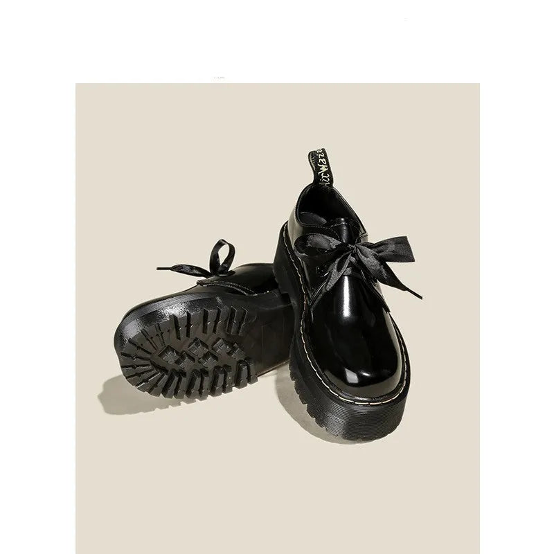 Women's thick soled leather shoes with ribbon cross straps and lace closure in black or white