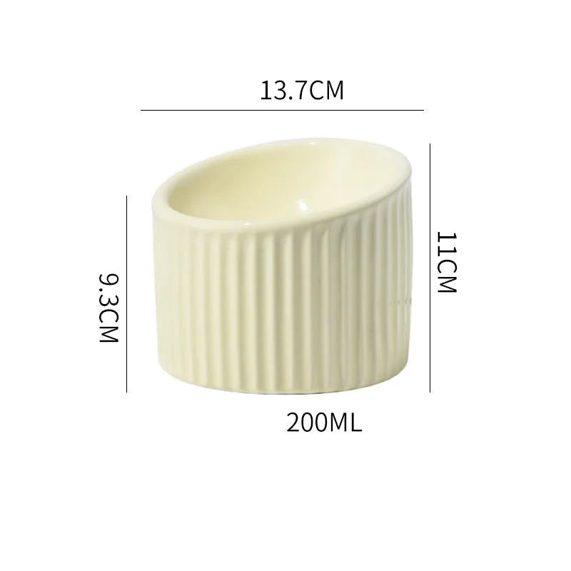 Elevated ceramic cat bowl in green colour with tilted design for whisker-friendly feeding
