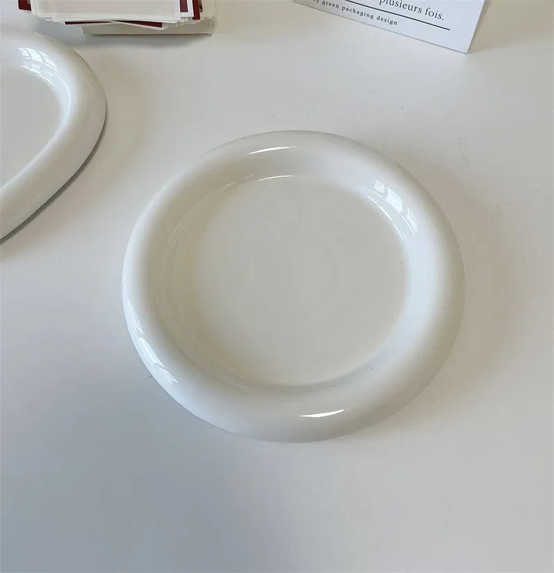 White porcelain plate with chubby toot or bear doodle pattern, shown in 15cm and 20cm round sizes.