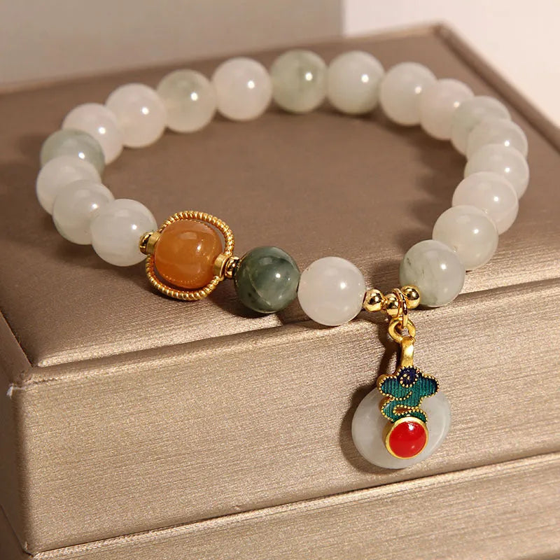 Women's ice jade bracelet with a pearl on the jade buckle.