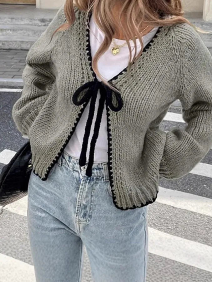 Grey lace-up sweater cardigan with long sleeves, a front crocheted flower, and a loose fit.