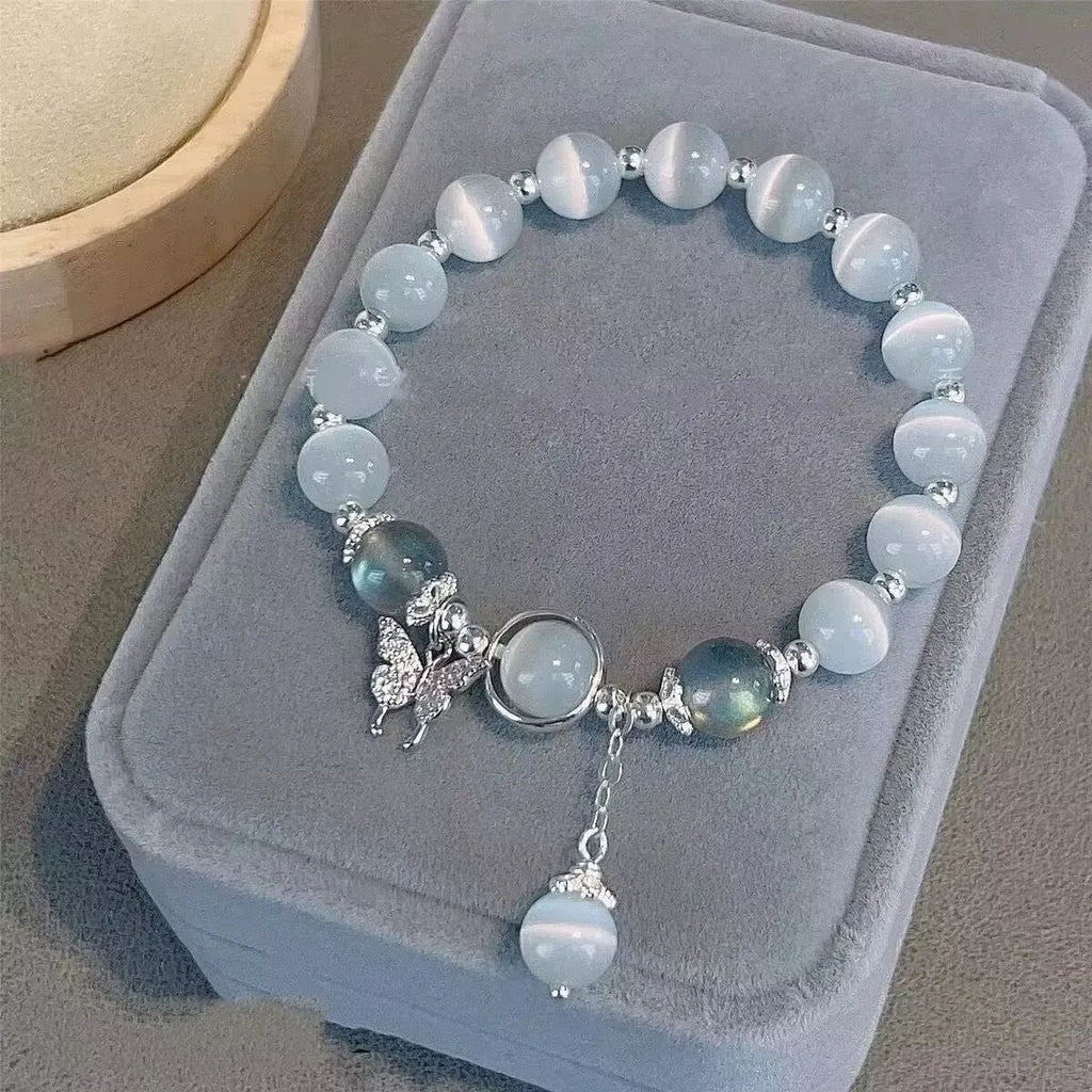 Handmade glass butterfly charm bracelet for women in a drop shape with round details.