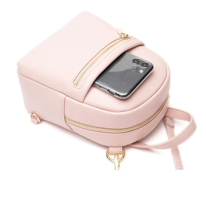 Soft black PU mini backpack with front pockets, shown open to reveal internal mobile phone sleeve and zipper compartment.