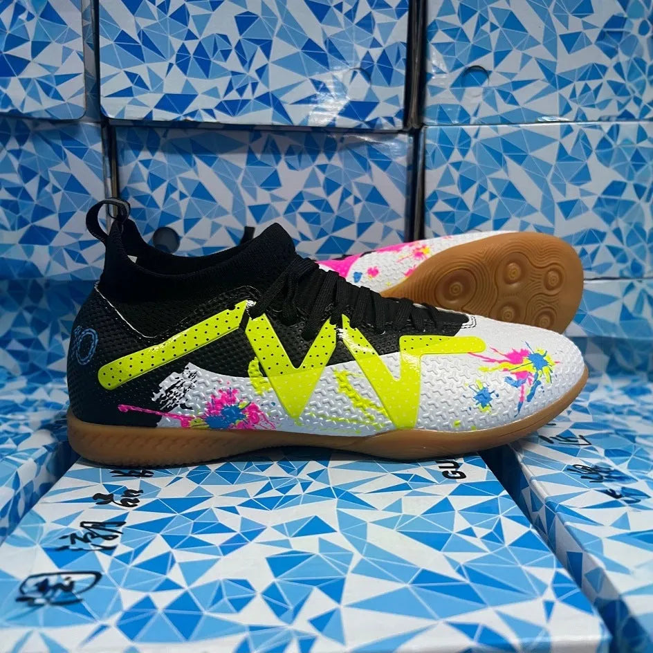 Low-top football shoes with studded rubber outsoles in black and yellow colour combination