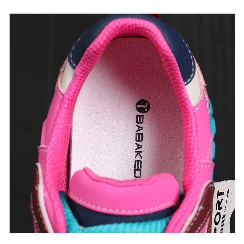 A pair of thick-soled leather casual shoes in a black and white colourway, showing the round toe and lace-up front.