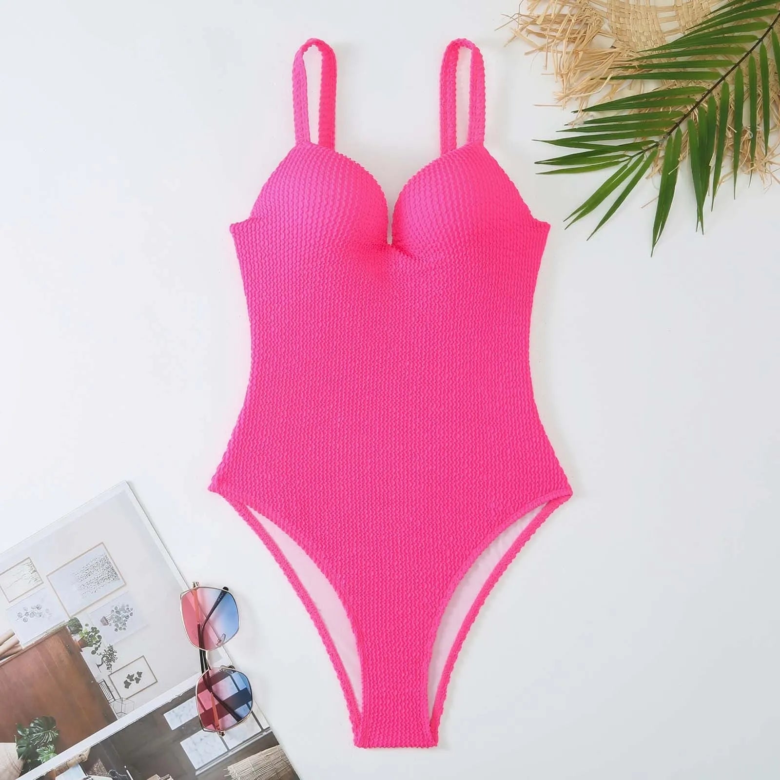 A women's sleeveless one-piece swimsuit on a hanger, shown in black, with other colour options available.