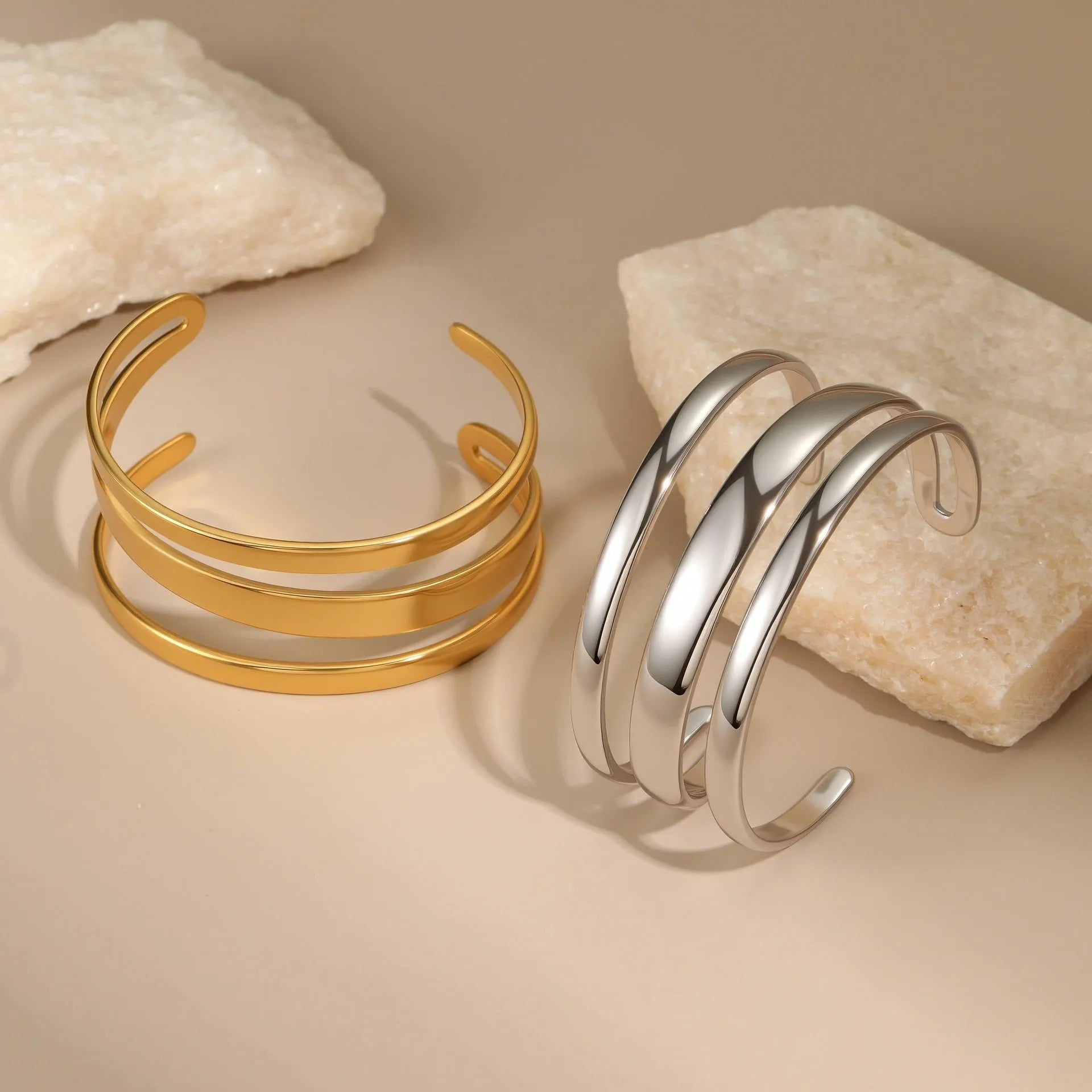 Geometric stainless steel women's bracelet with a simple opening mechanism, shown in gold and steel finish options.