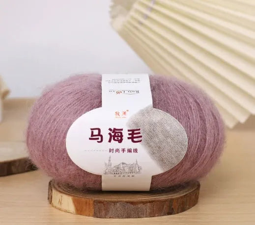 DIY mohair scarf weaving kit showing one wool ball and a selection of 34 colour options including white, pink, blue and green.