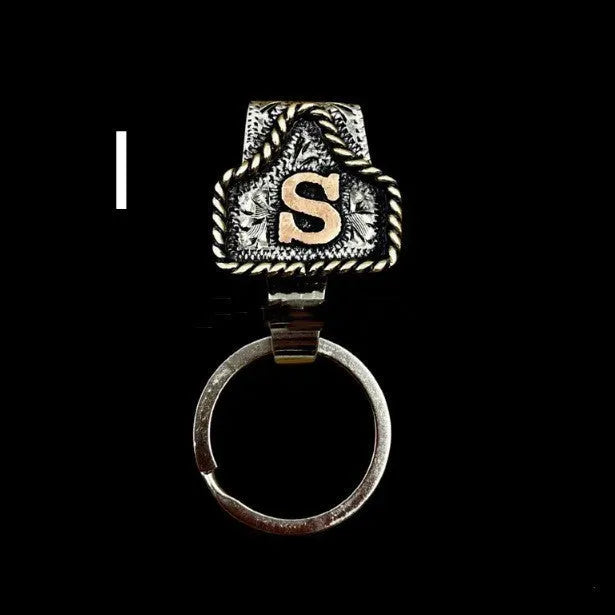 Handmade metal cow tag belt key holder keychain on a key ring, showing the metal loop and tag design.