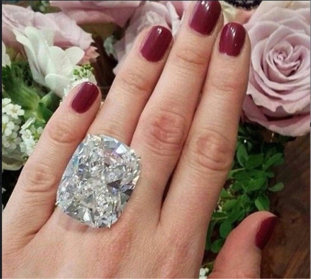 Women's simple geometric alloy ring with a square diamond inlay in white gold colour, shown on a finger.