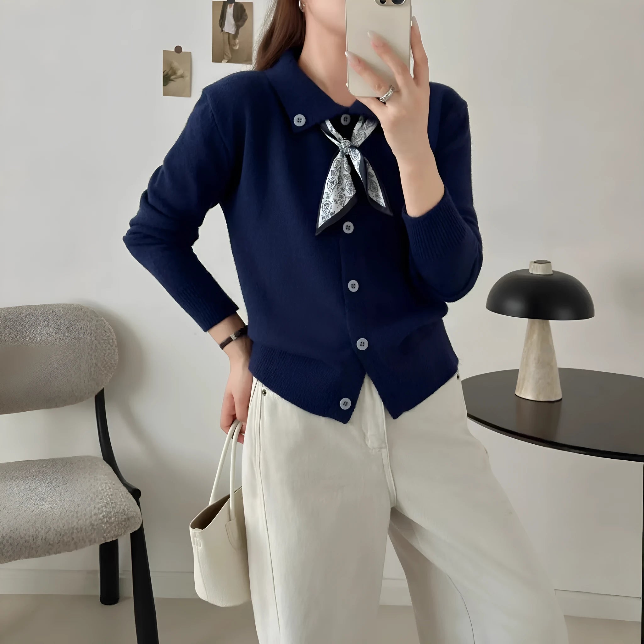 Women's beige lapel scarf collar acrylic cardigan sweater on a hanger.