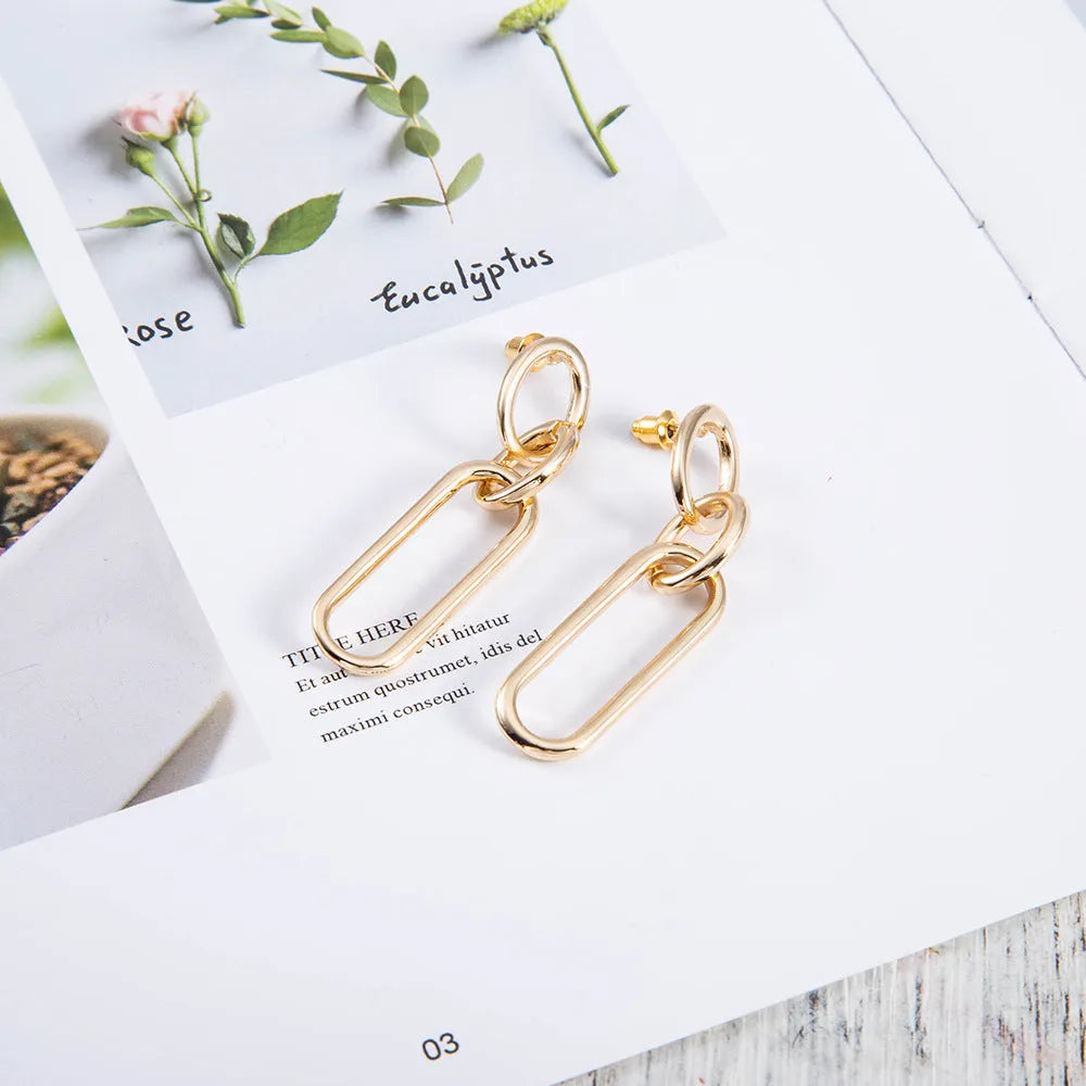 Geometric sterling silver needle hoop earrings with line and ring design elements