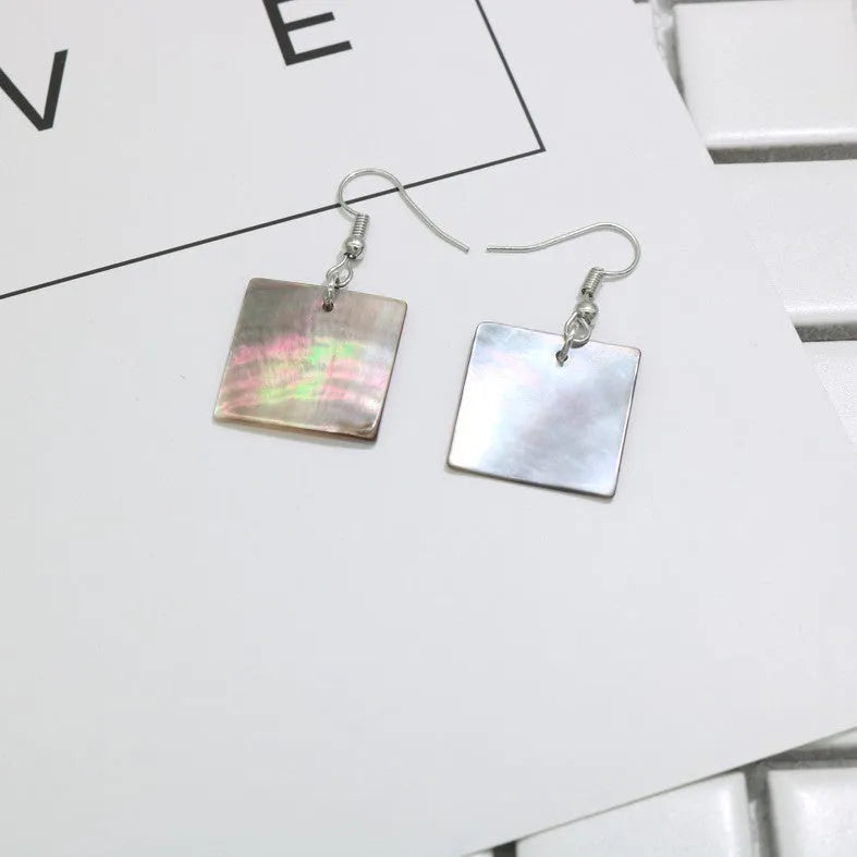 A pair of geometric-shaped women's earrings made from natural shell in a retro style.