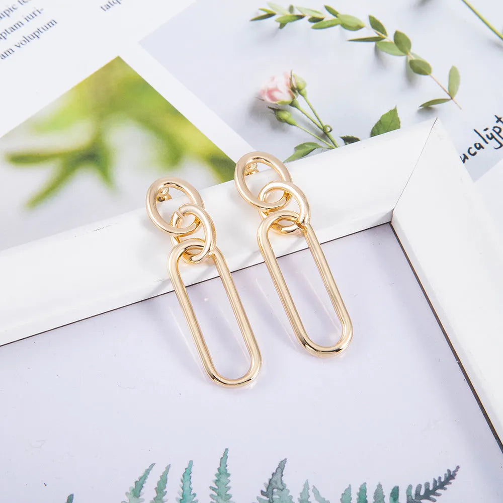 Geometric sterling silver needle hoop earrings with line and ring design elements
