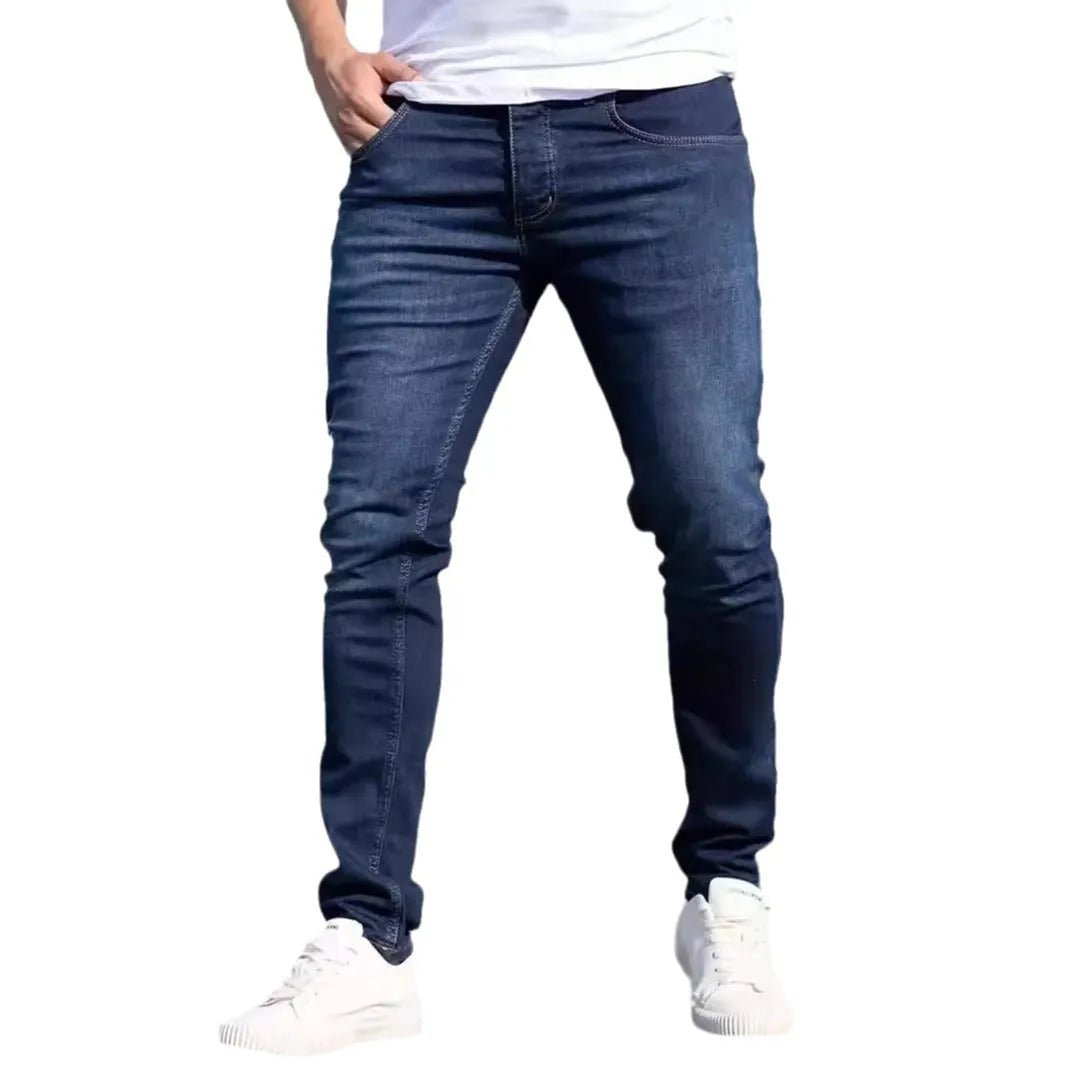 Men's dark blue slim casual jeans with medium elastic waist and skinny leg style