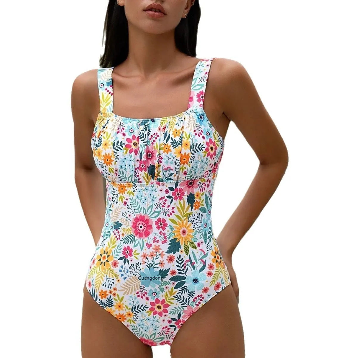 Women's pastoral floral print one-piece swimsuit on a hanger, showing the full design.