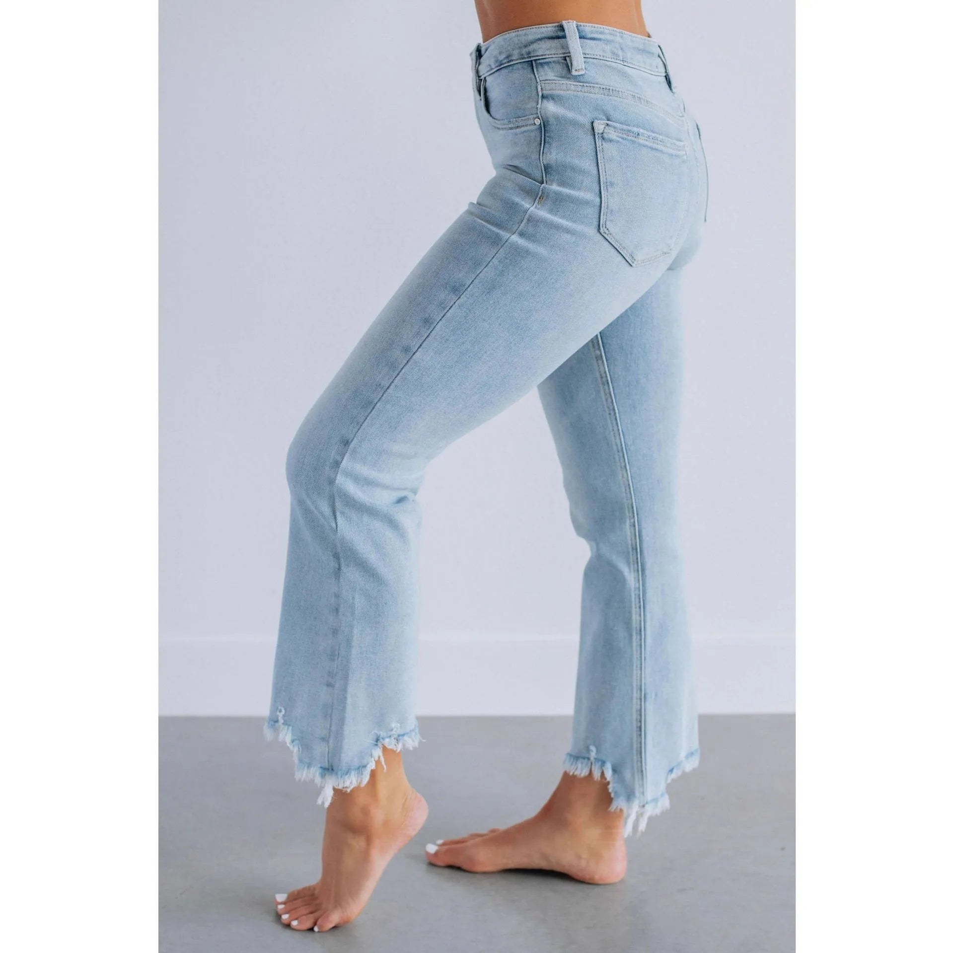 Women's solid colour denim jeans with hand-sanded distressing in dark blue and light blue colour options