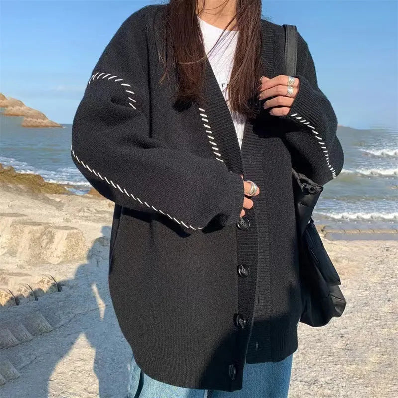 Women's loose fit knitted cardigan coat in black or white with long sleeves
