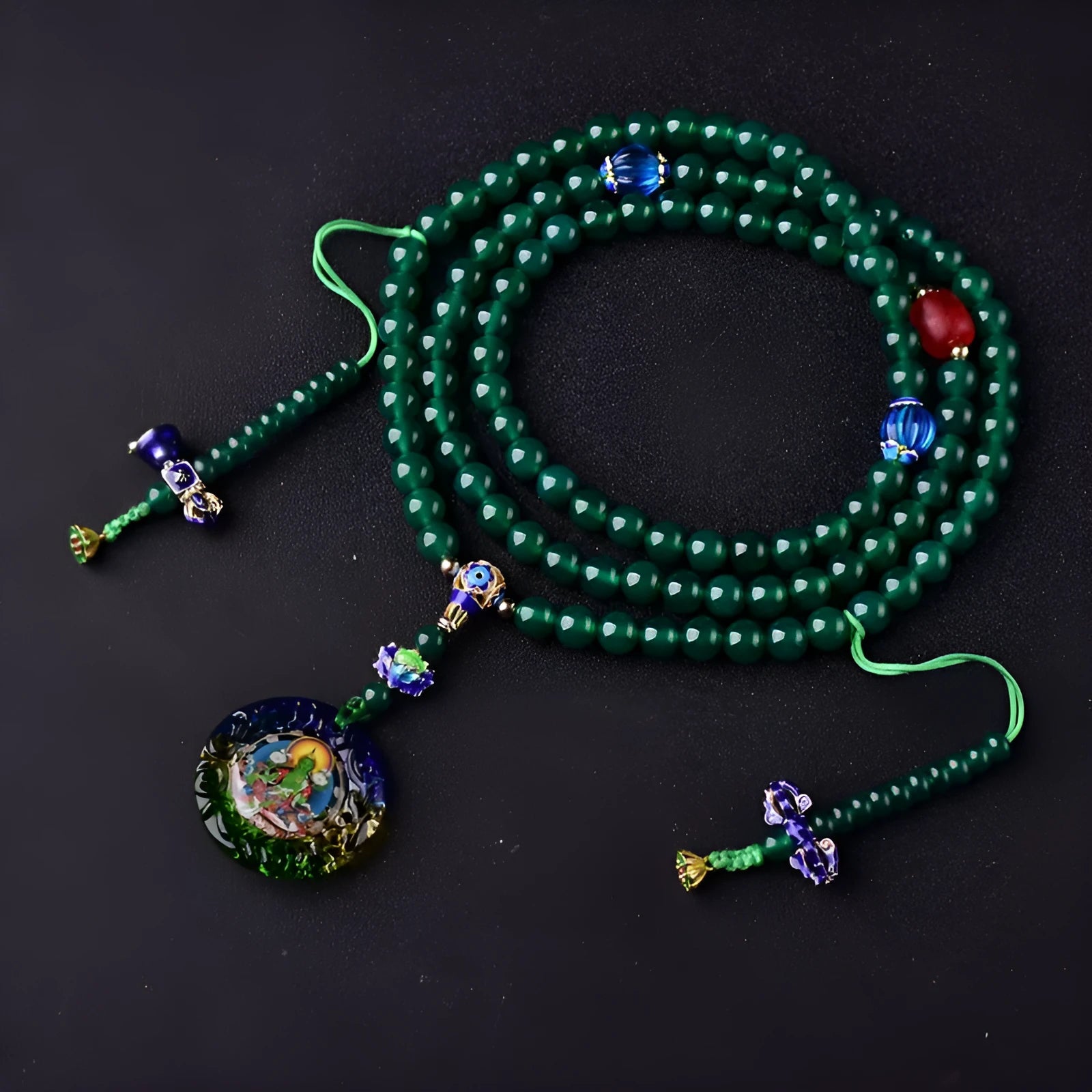 Handmade green agate bracelet with a detailed thangka pendant and multi-circle bead design.