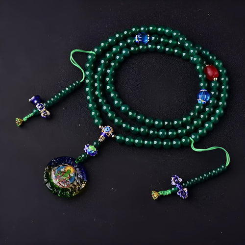 Handmade green agate bracelet with a detailed thangka pendant and multi-circle bead design.