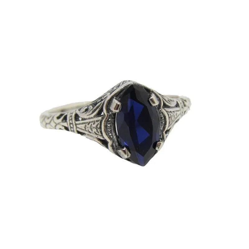 Women's geometric hollow ring in electroplated silver with zircon detail, showing openwork pattern