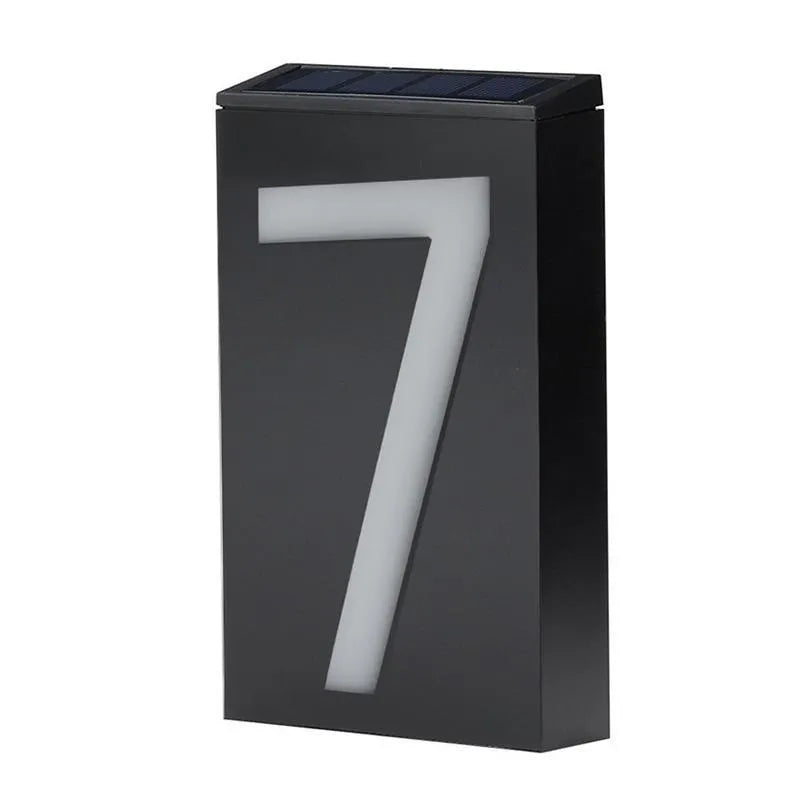 Solar-powered white LED house number light mounted on an outdoor wall