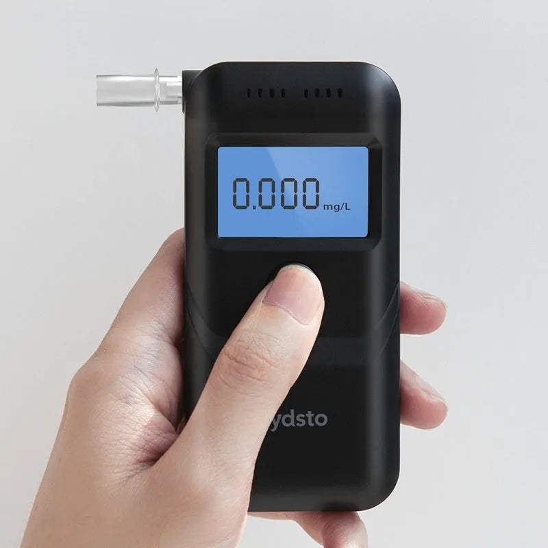 Black household alcohol breath tester with compact design for drinking level monitoring